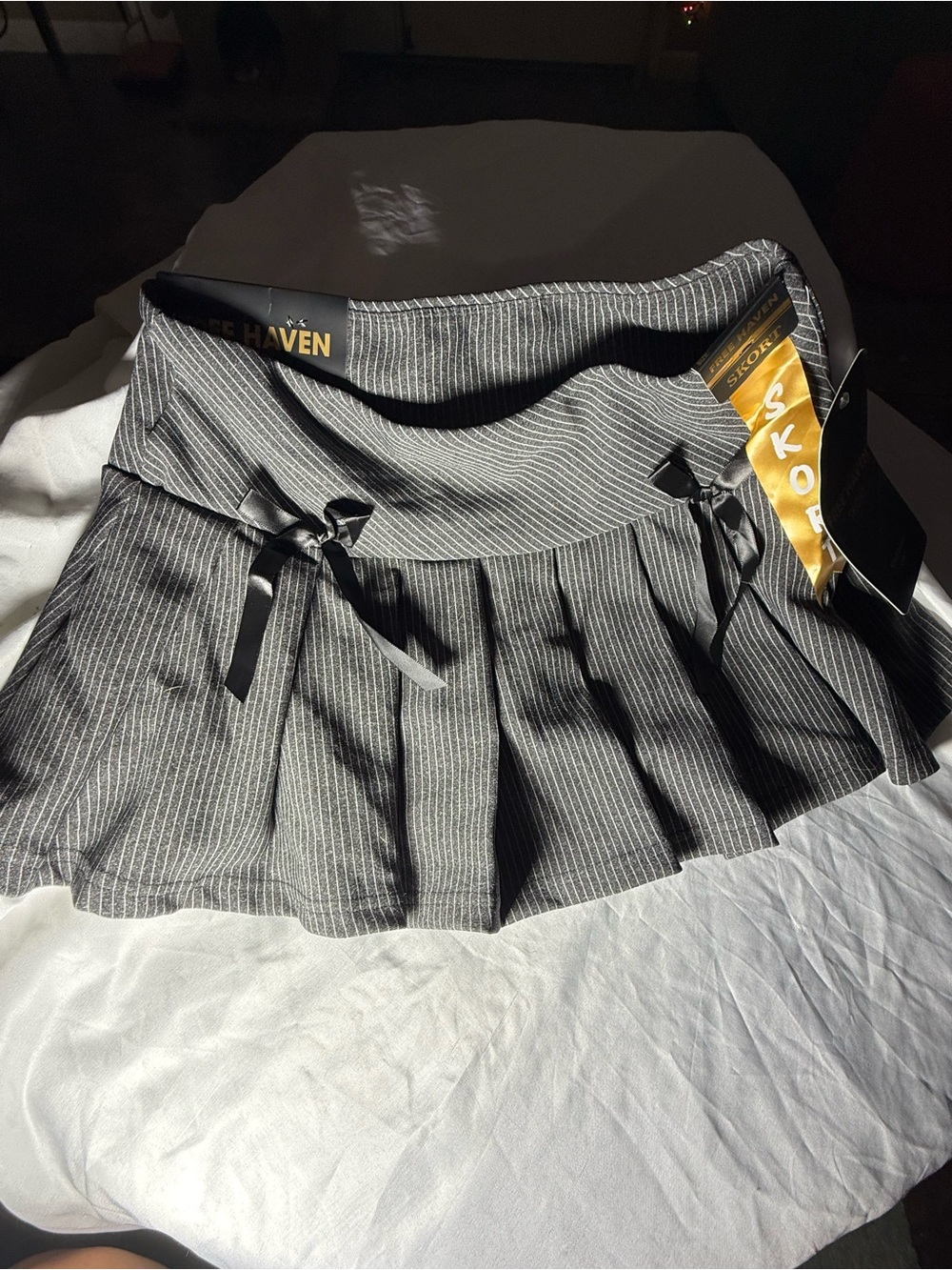 Free Haven Women's Pinstripe Pleated Mini Skort with black bow accents- Black- L